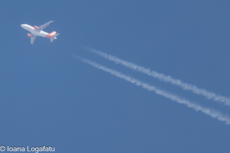 Jet soaring high against a clear blue sky